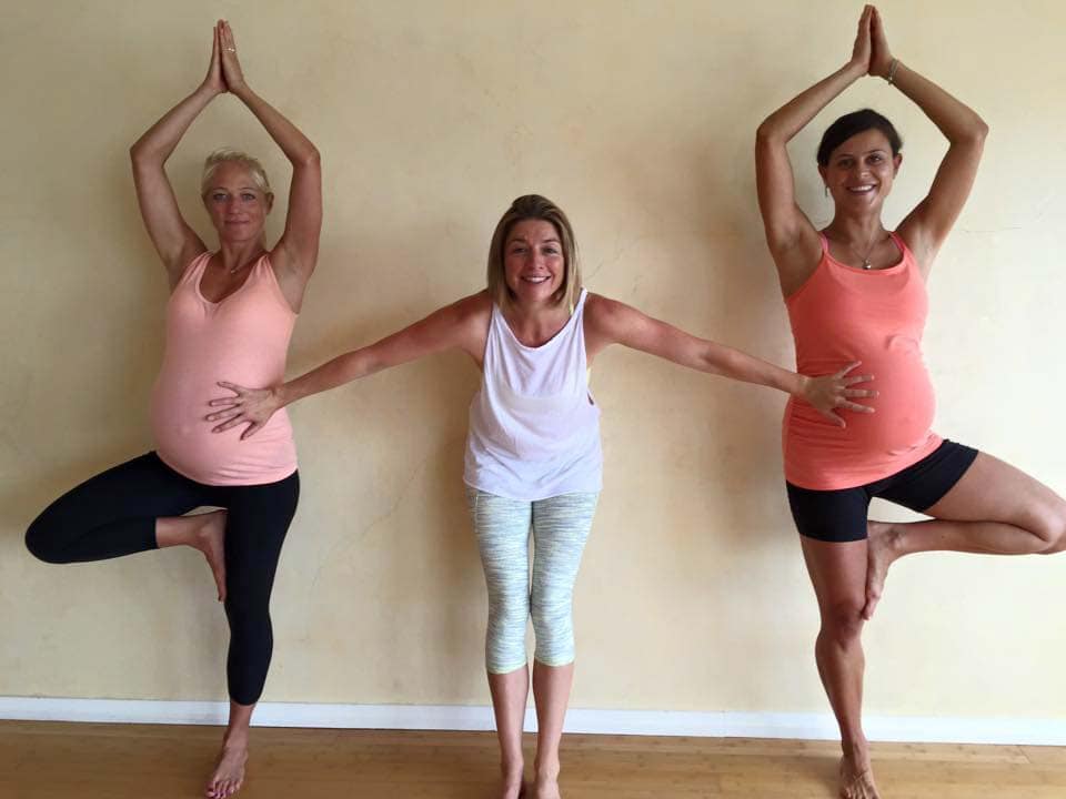 Nadine Richardson with two pregnant women doing She Births® prenatal yoga